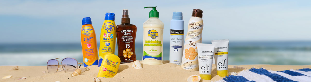 Sunscreen for the family in the sand at the beach.