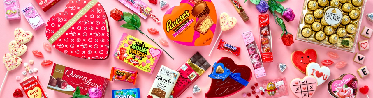 Valentine's candy favorites from pOpshelf: Heart-shaped boxed candy, Reese's cups,  Dove chocolate, Ferrero Rocher, conversation hearts, chocolate roses, Ghirardelli, Kinder Love & more.