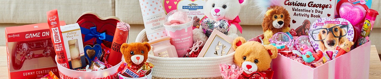 Gift baskets full of Valentine's candy, plush, and other gifts for her, him, and kids.