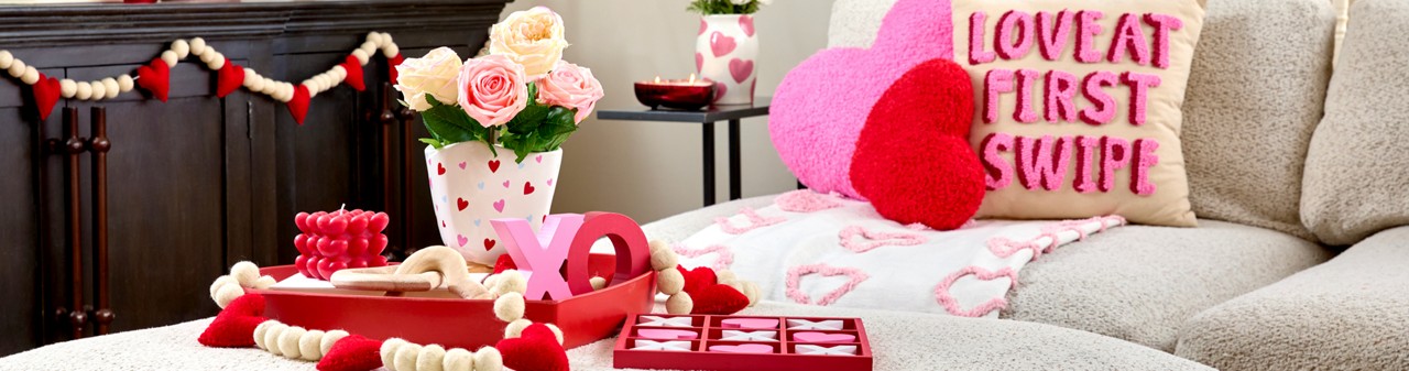 Living room decorated with pOpshelf Valentine's Day home decor pieces: heart pilows, heart wall art, Valentine's candles, and valentine's day decor items.