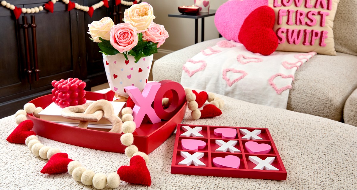 Living room decorated with pOpshelf Valentine's Day home decor pieces: heart pilows, heart wall art, Valentine's candles, and valentine's day decor items.