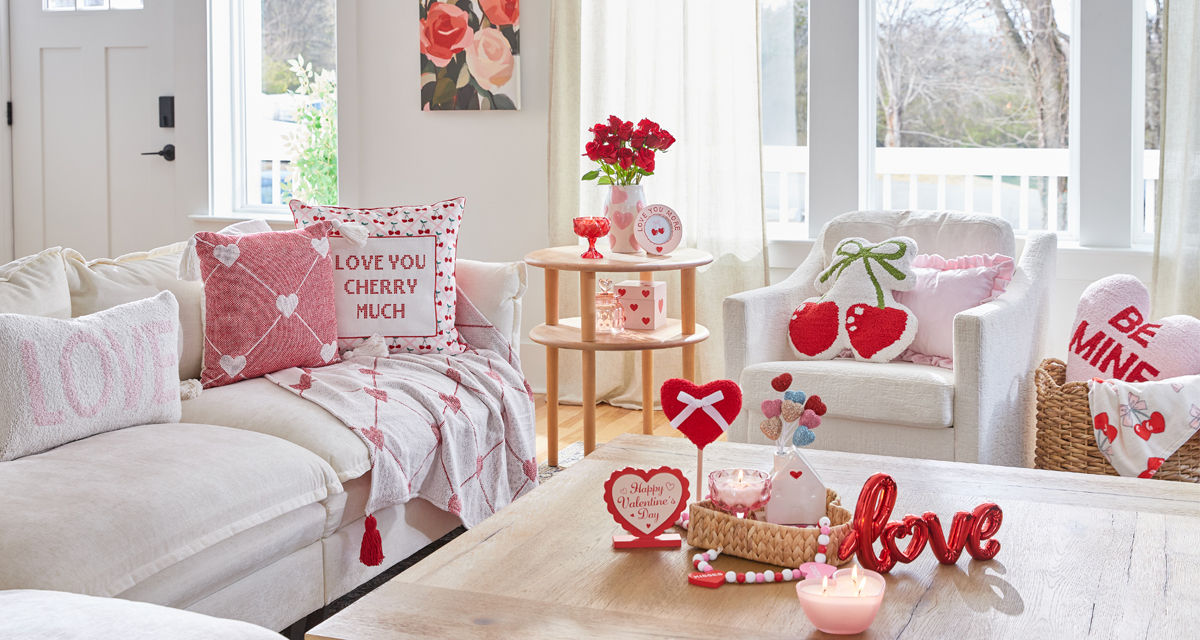 Living room decorated with pOpshelf Valentine's Day home decor pieces: heart pilows, floral wall art, Valentine's candles, and valentine's day decor items.