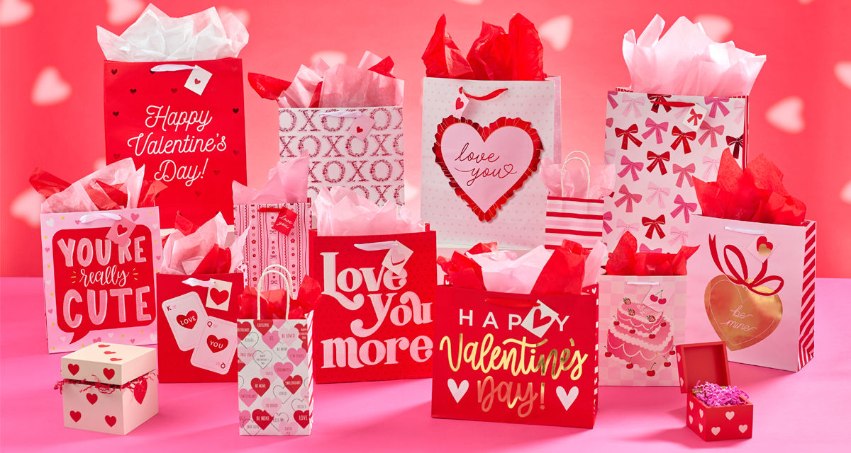 Various Valentine's Day gift bags, pink and red tissue paper, valentine's day boxes, and valentine's bows and ribbon from pOpshelf. 
