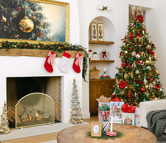 A living room is decorated with classic Christmas decorations from pOpshelf including a festive Christmas tree, a fireplace finished with garland and stockings, and holiday accents sitting on accent tables throughout the room.