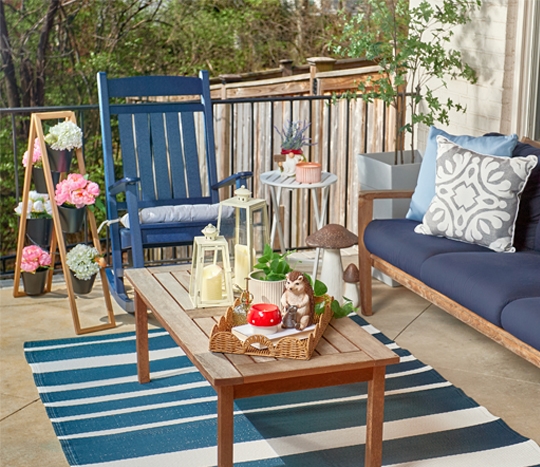 Patio decorated with new lawn & garden decor, pillows, chair cushions, and planters from pOpshelf.