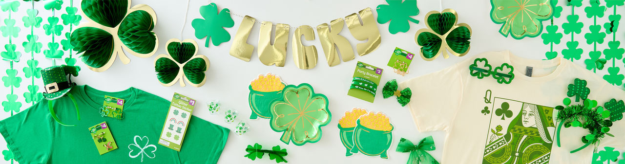 St. Patrick's Day party supplies: rainbow and shamrock plates, green beer mugs, necklaces, shamrock wall garland, pot-of-gold napkins & more.