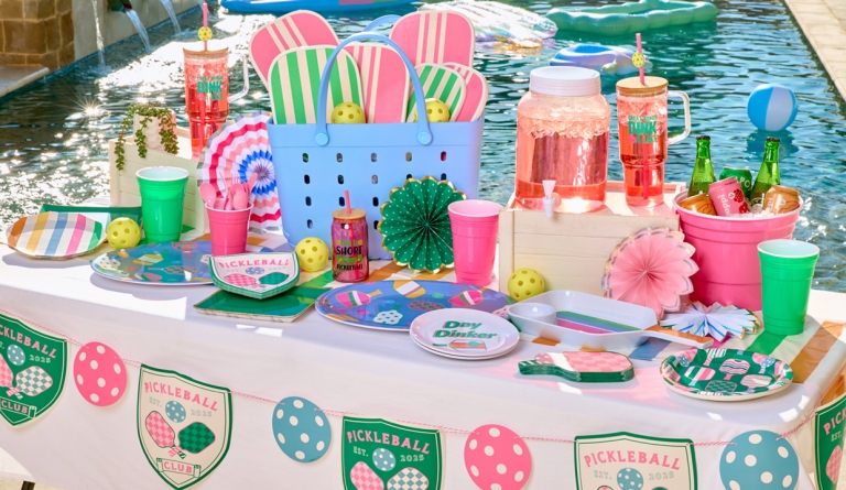 Pickleball-themed party supplies: paper plates & napkins, 40-oz. travel cup, pickleball rackets, decorations, serveware & more.