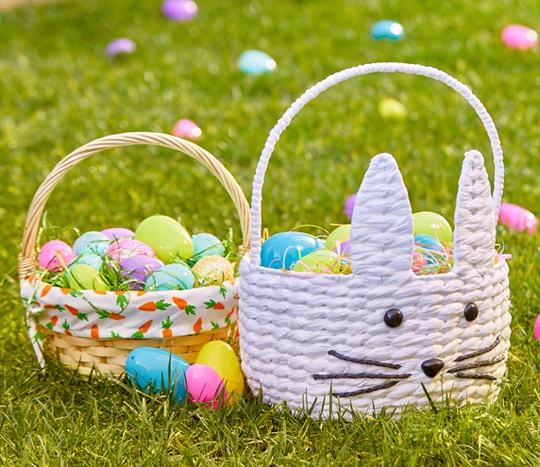 Easter baskets from pOpshelf filled with Easter grass and plastic fillable Easter eggs at an egg hunt.