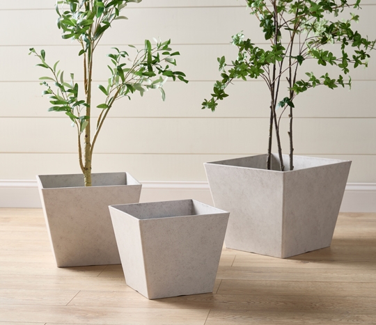 Light gray square planters in various sizes.