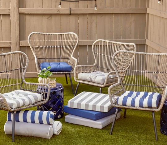 Patio chairs with replacement chair cushions from pOpshelf in solid gray and blue, blue & white and gray & white striped, and sold & striped matching bolster cushions.
