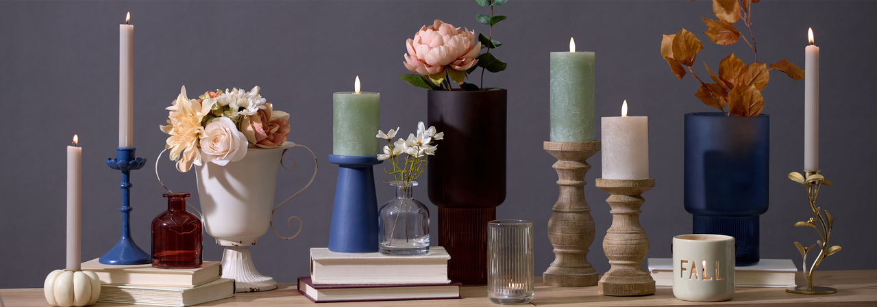 Fall vases and candleholders in various designs and colors in a kitchen.