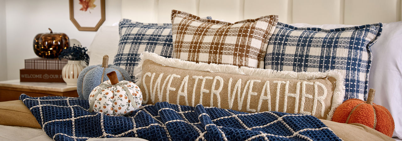 Bedroom decorated for fall with pumpkin decor, fall floral, fall pillows and throws & more.