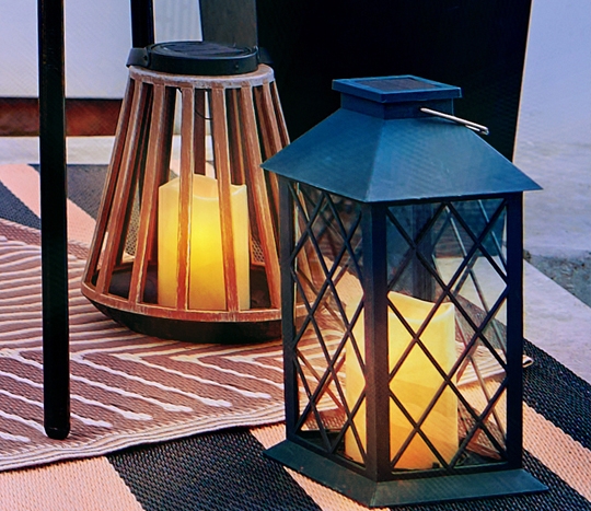 Outdoor string lights and solar lanterns from pOpshelf on a backyard patio.