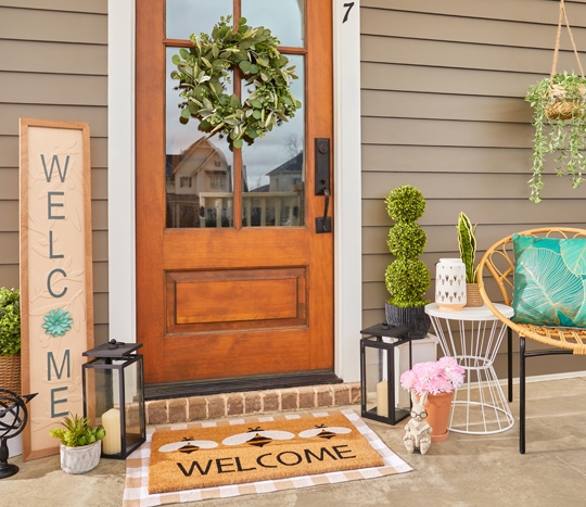 Front porch decorated with garden & patio décor from pOpshelf: lanterns, porch leaner, potted plants, metal garden decor & more.